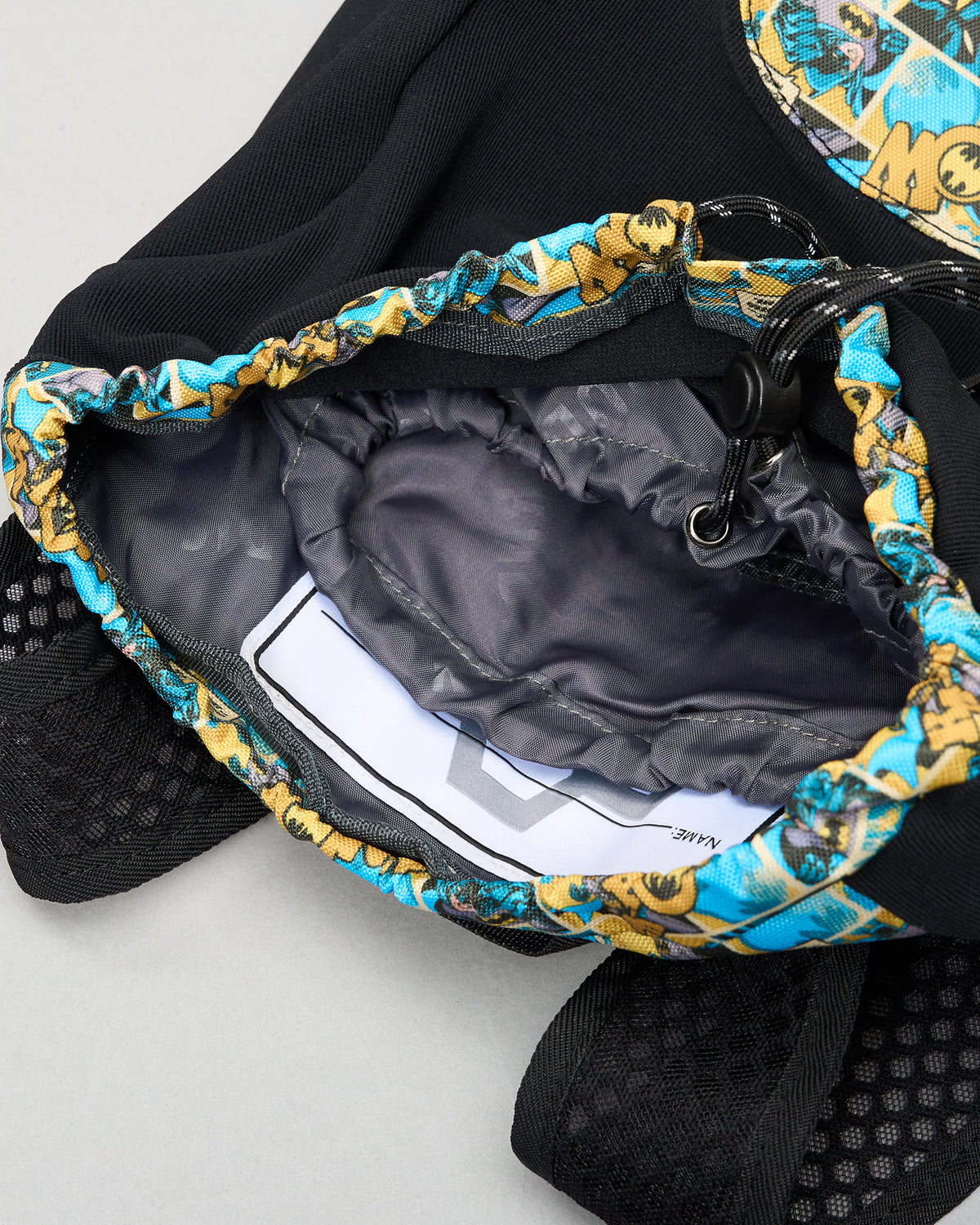 Close-up of the RUDIS Batman Double Cinch wrestling backpack drawstring opening, interior lining, cord lock, and Batman comic-print trim.