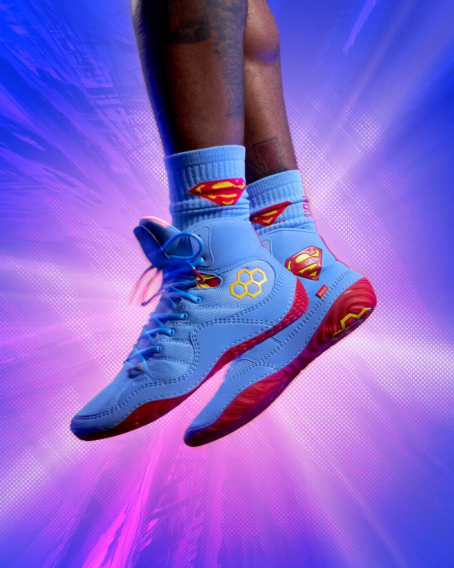 Blue RUDIS Superman Cushion Crew Socks worn with matching blue Superman wrestling shoes, featuring red and yellow shield details.