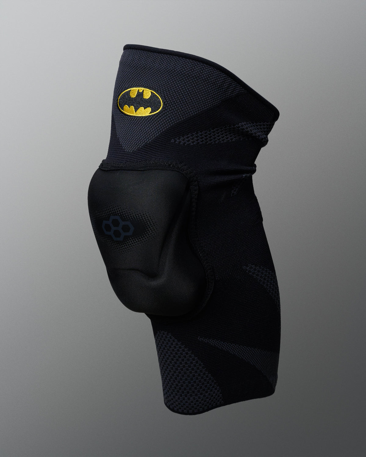 Front angled view of the RUDIS Batman Elite Cushion wrestling knee pad in black with protective padding and embroidered Batman logo.