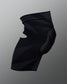 Rear angled view of the RUDIS Batman Elite Cushion wrestling knee pad showing the black compression sleeve and contoured knee padding.