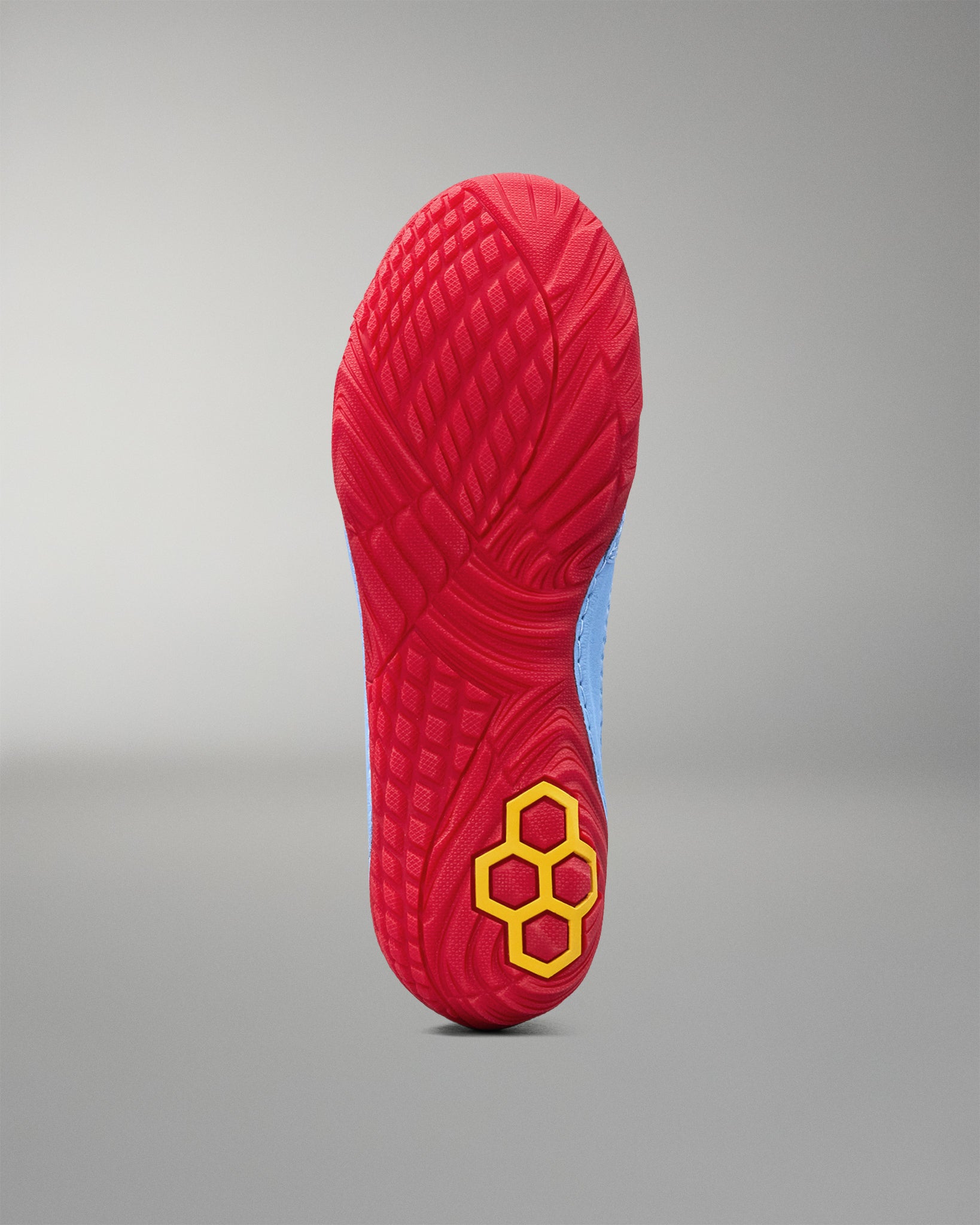 Bottom view of RUDIS JB1 Superman wrestling shoe showing the textured red outsole and yellow RUDIS logo.