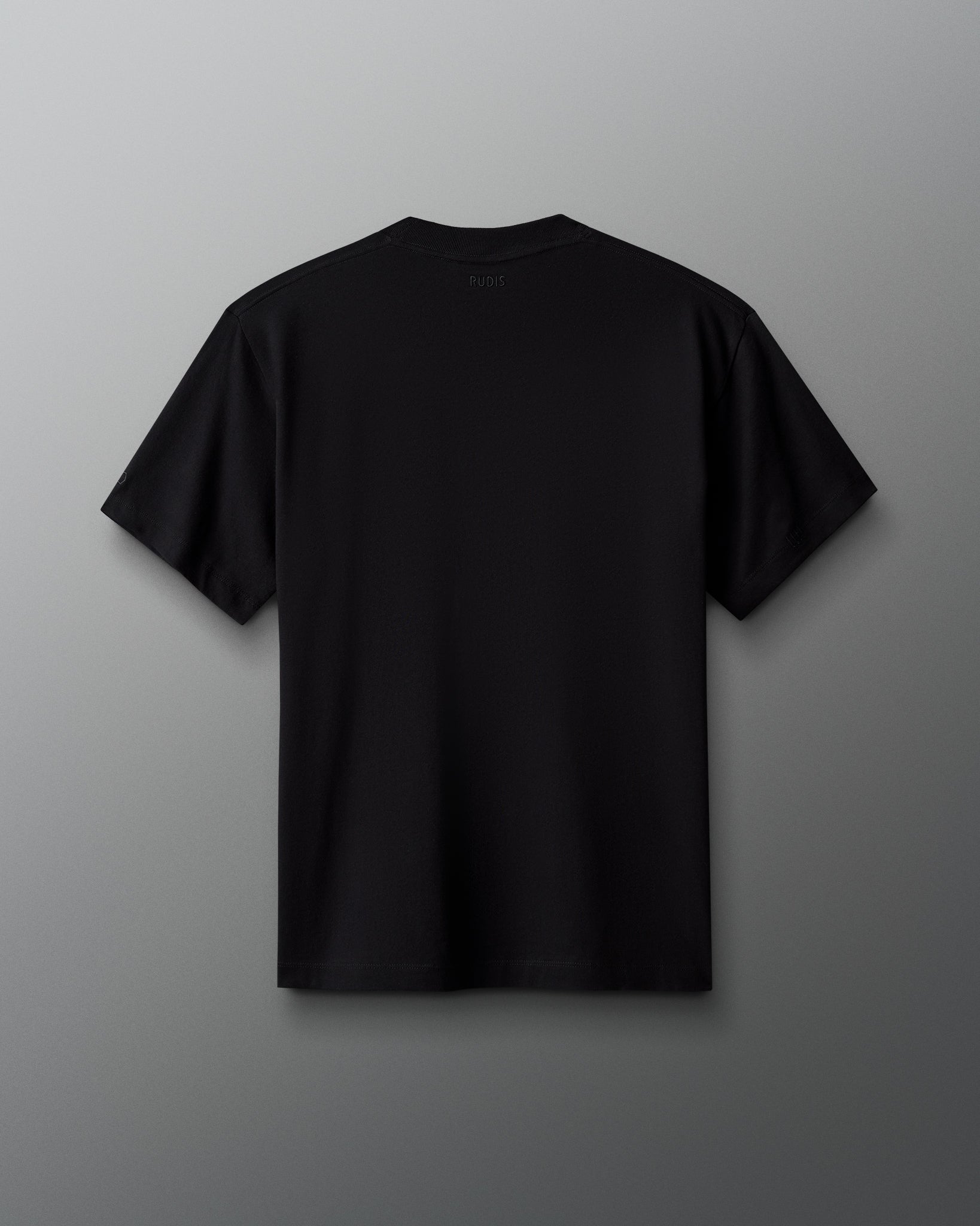 Back view of the RUDIS Scooby-Doo Relaxed Cotton T-Shirt in black, featuring a clean, solid-color design, short sleeves, crew neckline, and subtle RUDIS branding below the back collar.