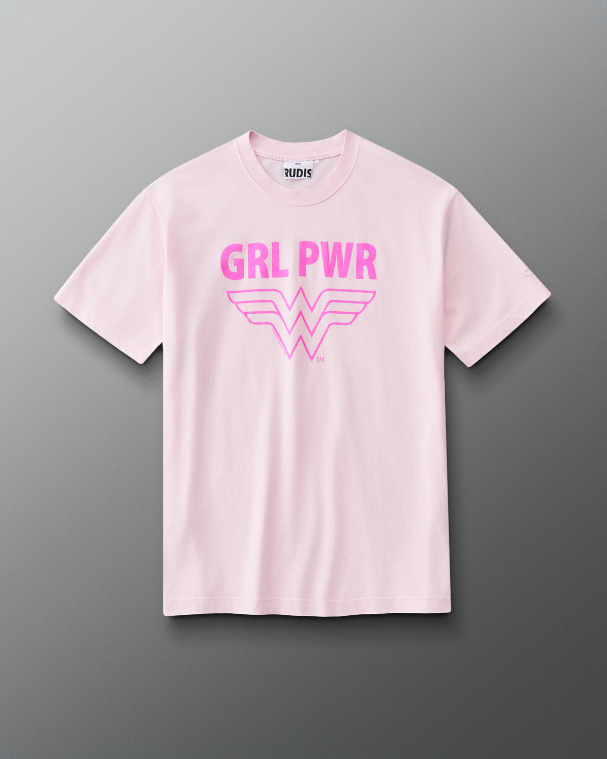 Front view of RUDIS Wonder Woman Girl Power Relaxed Cotton T-Shirt in washed pink with a vibrant pink GRL PWR graphic, Wonder Woman emblem, crew neckline and short sleeves.
