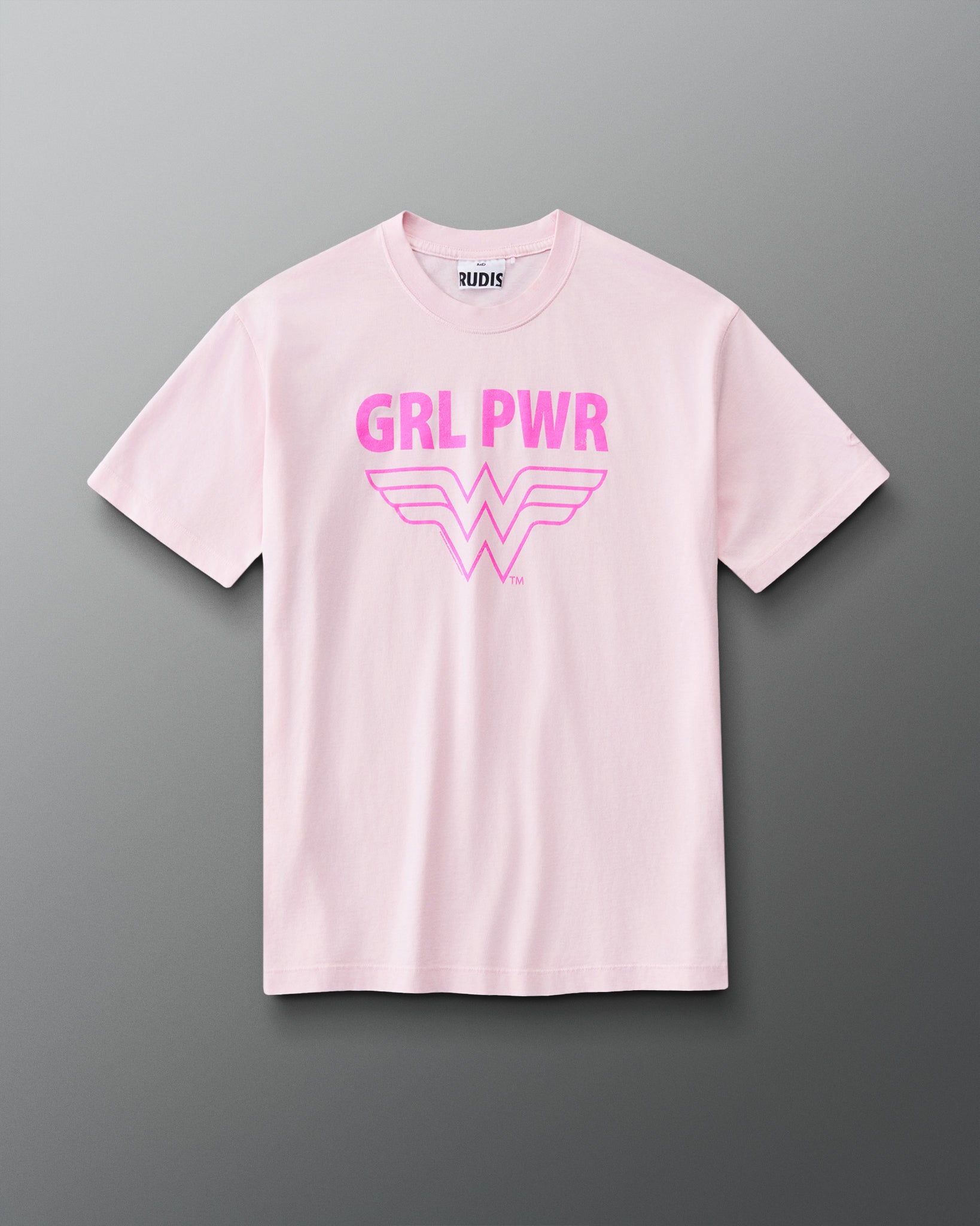 Front view of RUDIS Wonder Woman Girl Power Relaxed Cotton T-Shirt in washed pink with a vibrant pink GRL PWR graphic, Wonder Woman emblem, crew neckline and short sleeves.