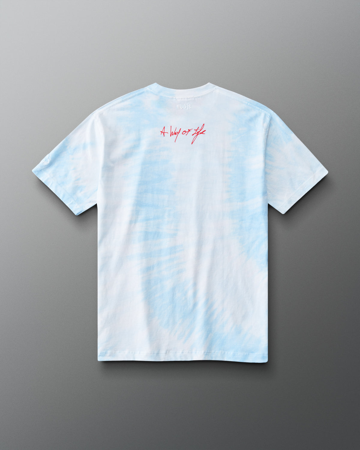 Back view of RUDIS Wonder Woman Comic Relaxed Cotton T-Shirt in blue tie dye, featuring a relaxed silhouette and red A Way of Life script below the neckline.