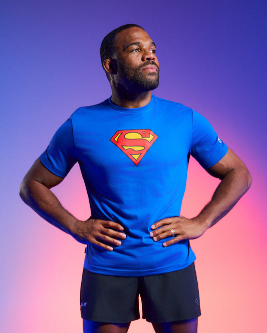 RUDIS Superman Icon Elite Supersoft T-Shirt in Royal featuring the classic Superman shield logo, worn with black athletic shorts.