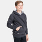 A young boy wearing a dark gray hoodie with a front pocket and a logo on the bottom left corner smiling at the camera