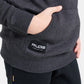 A close-up of a childs hand resting in the pocket of a dark gray hoodie featuring a black label with the word RUDIS and the phrase A WAY OF LIFE