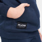 A close-up view of a navy blue sweatshirt with a visible RUDIS logo and a childs hand in the pocket