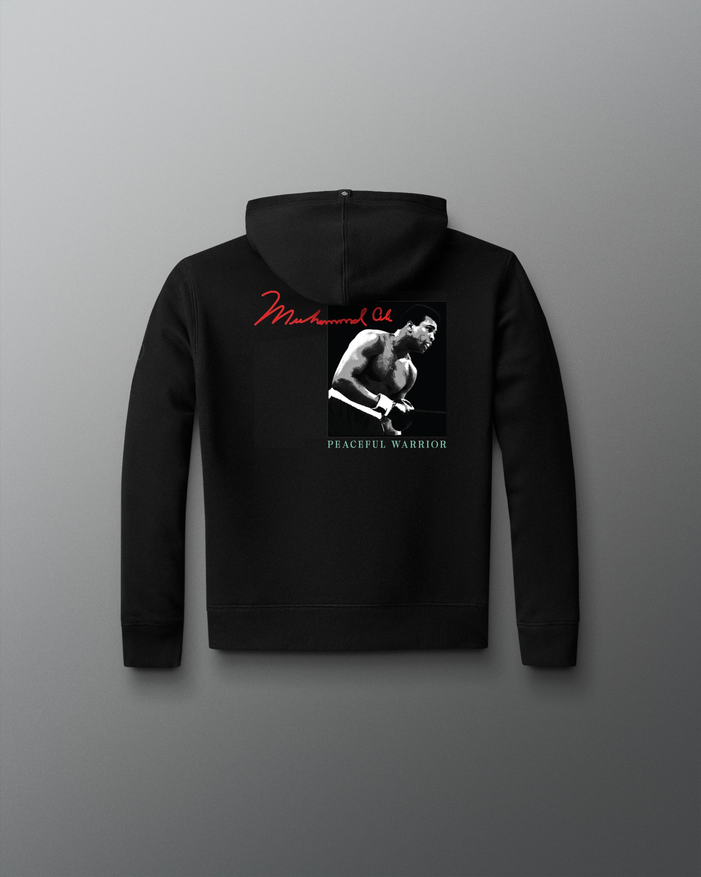 Black hoodie with a graphic design on the back against a gray background