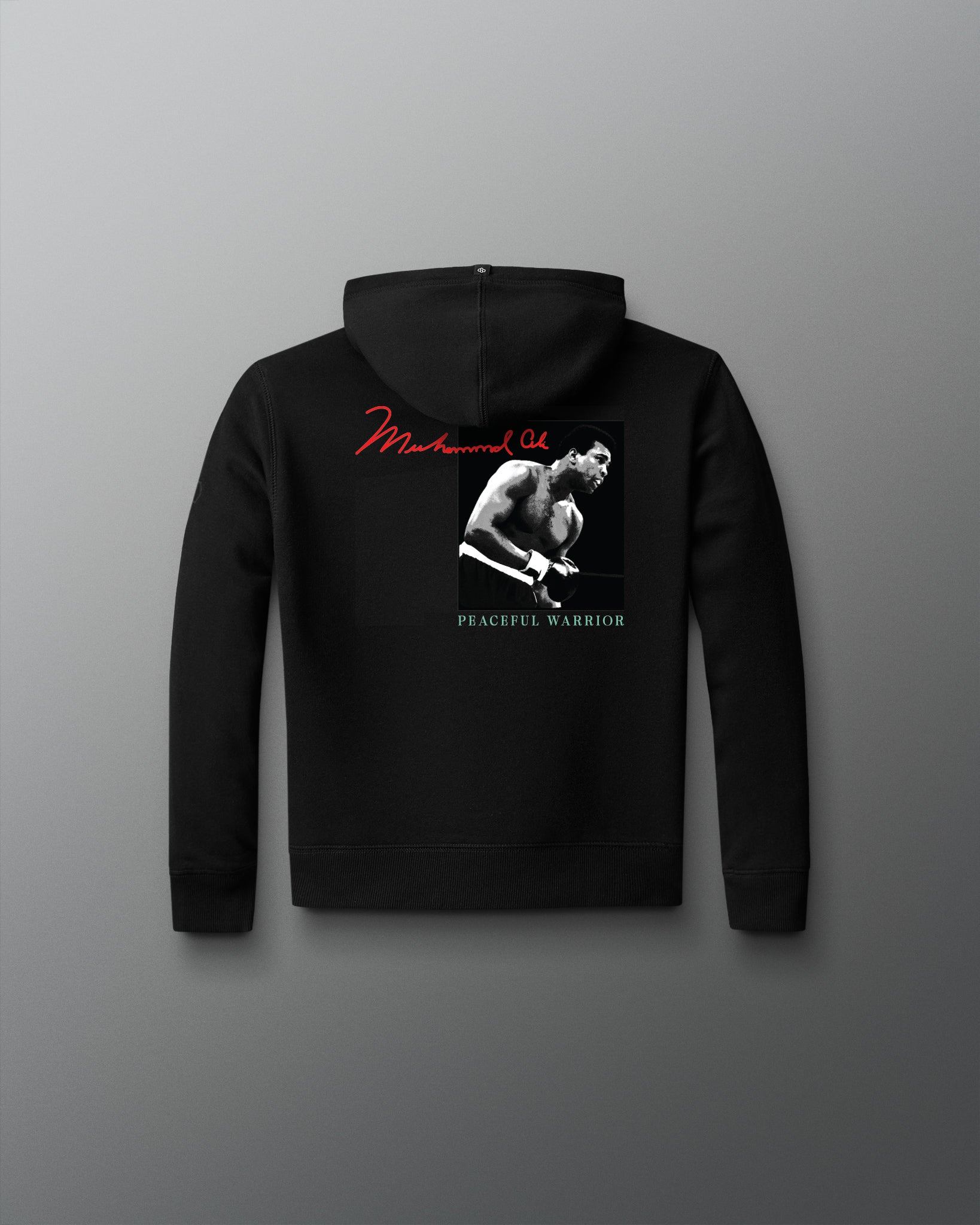 Black hoodie with a graphic design on the back against a gray background
