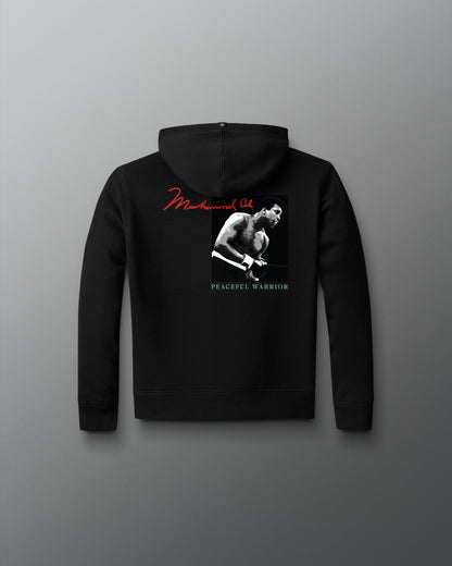 Black hoodie with a graphic design on the back against a gray background