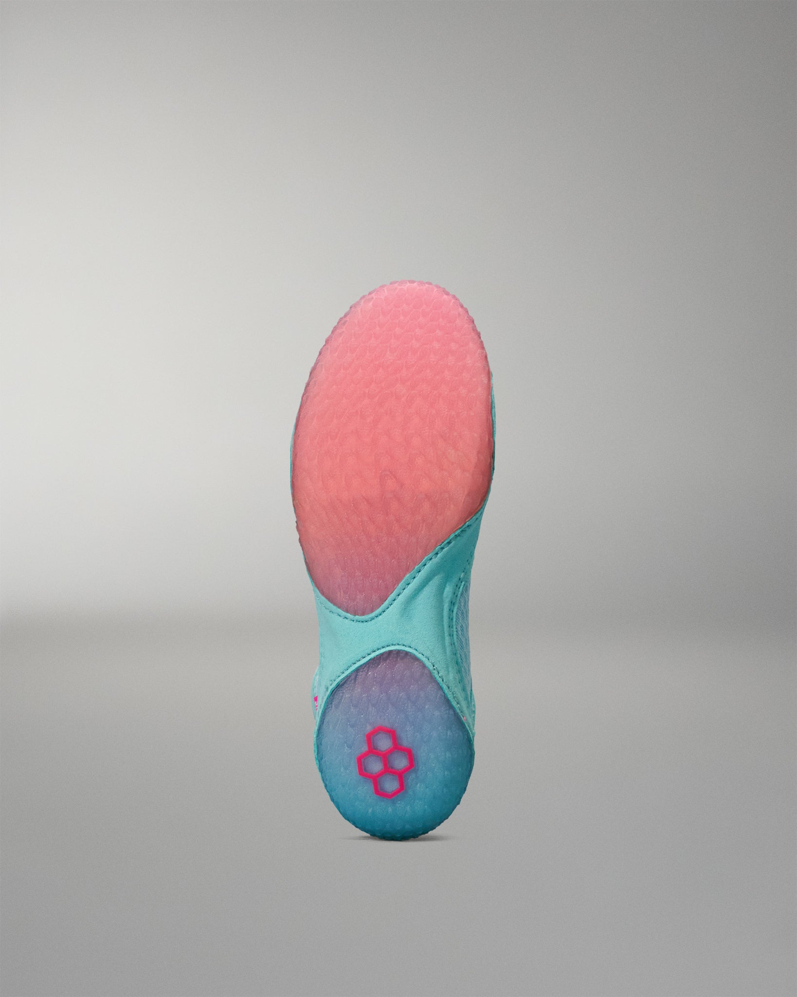Teal and pink Wrestling Shoe sole on a gray background