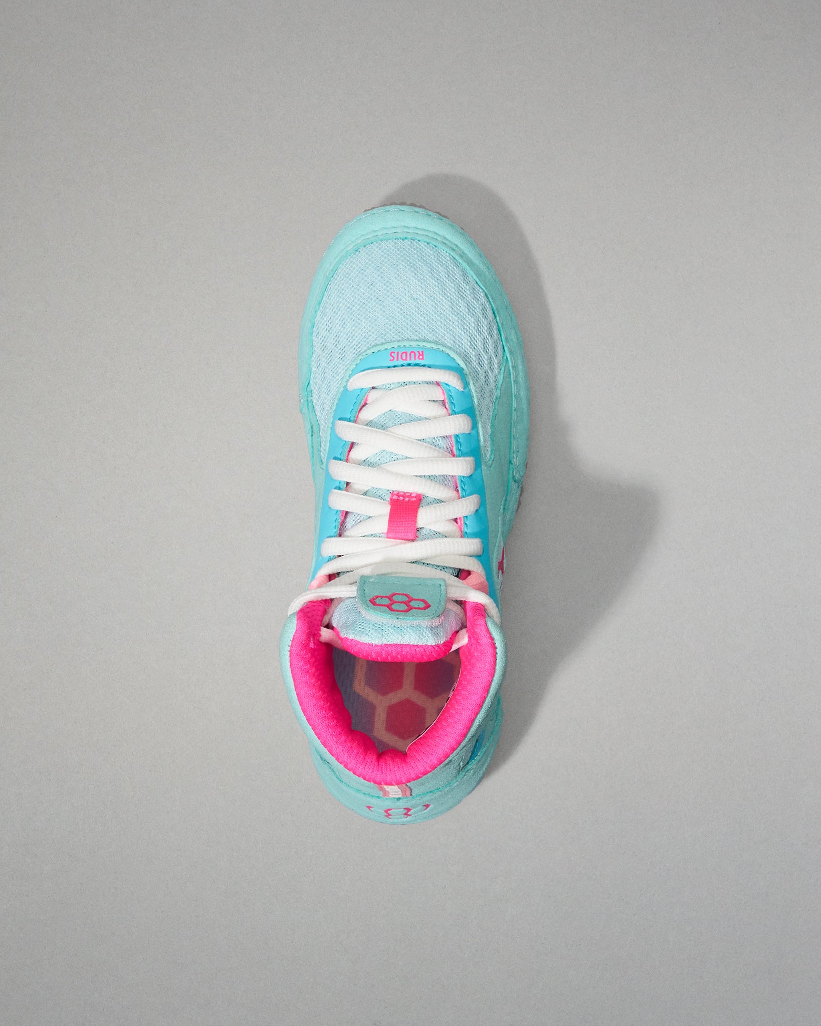Light blue Wrestling Shoe with pink interior on a gray background