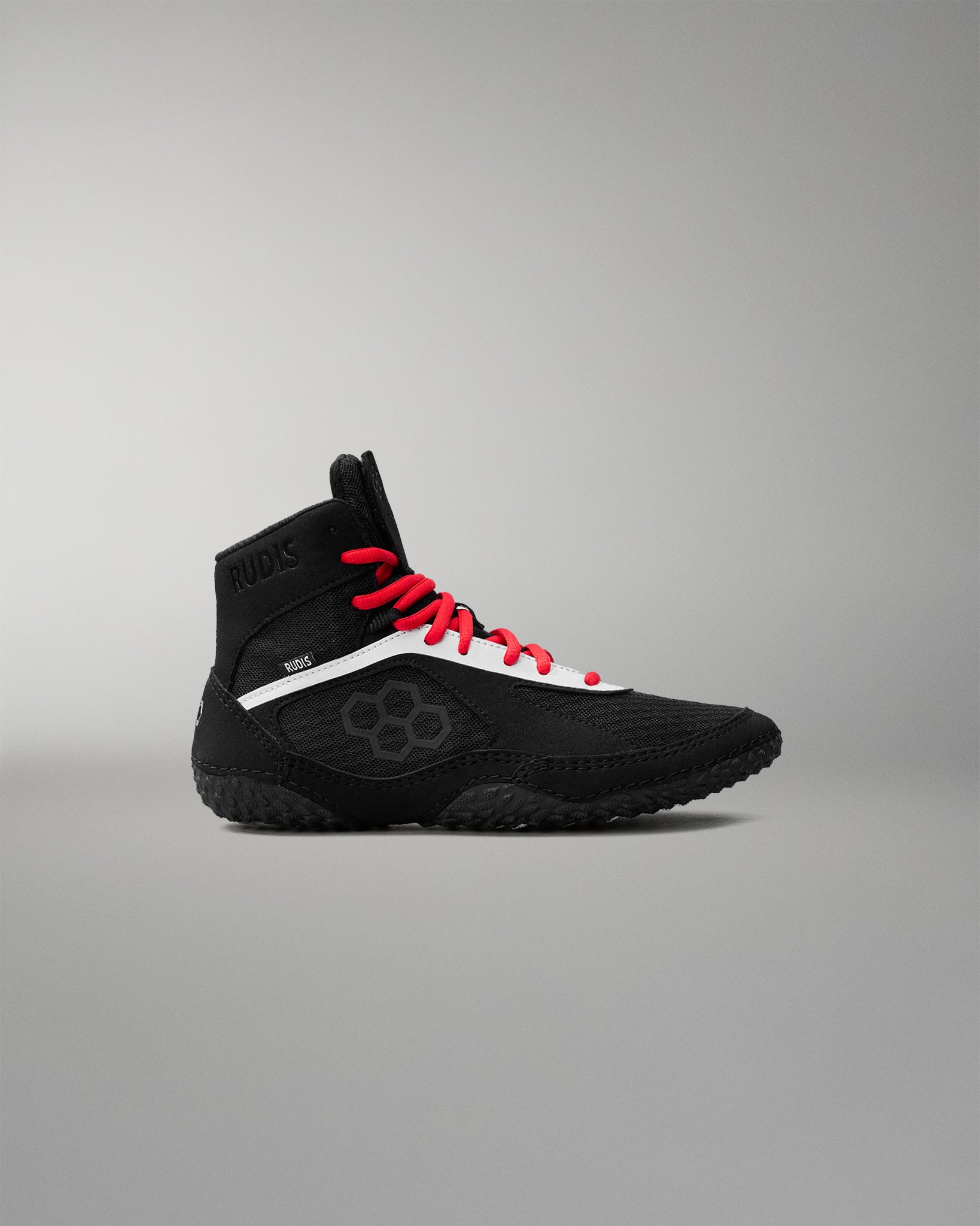 Black and red wrestling shoe on a gray background