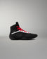 Black and red wrestling shoe on a gray background