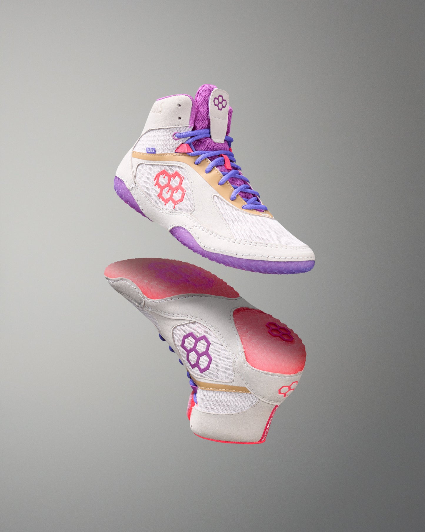 White wrestling shoes with purple, pink, and gold accents on a gray background