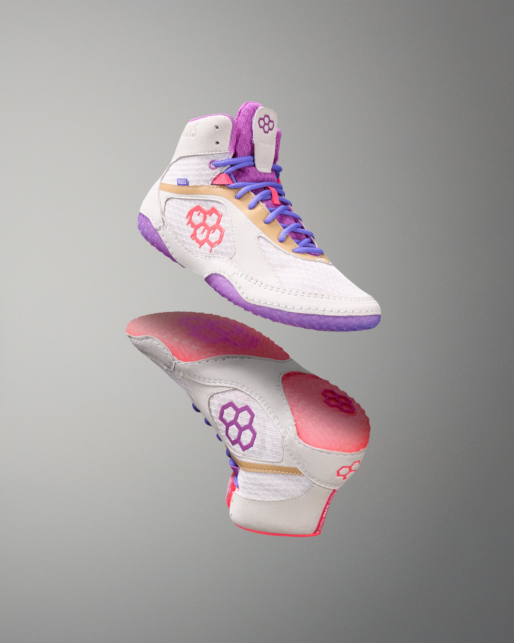 White wrestling shoes with purple, pink, and gold accents on a gray background