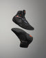 Black wrestling shoe with orange accents on a gray background