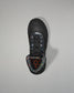 Black wrestling shoe with a unique sole design on a gray background