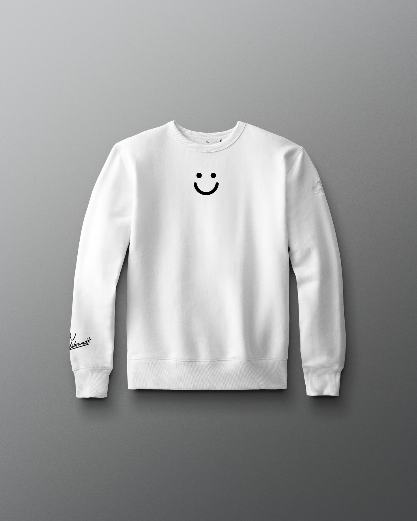 White sweatshirt with a smiley face design on a gray background