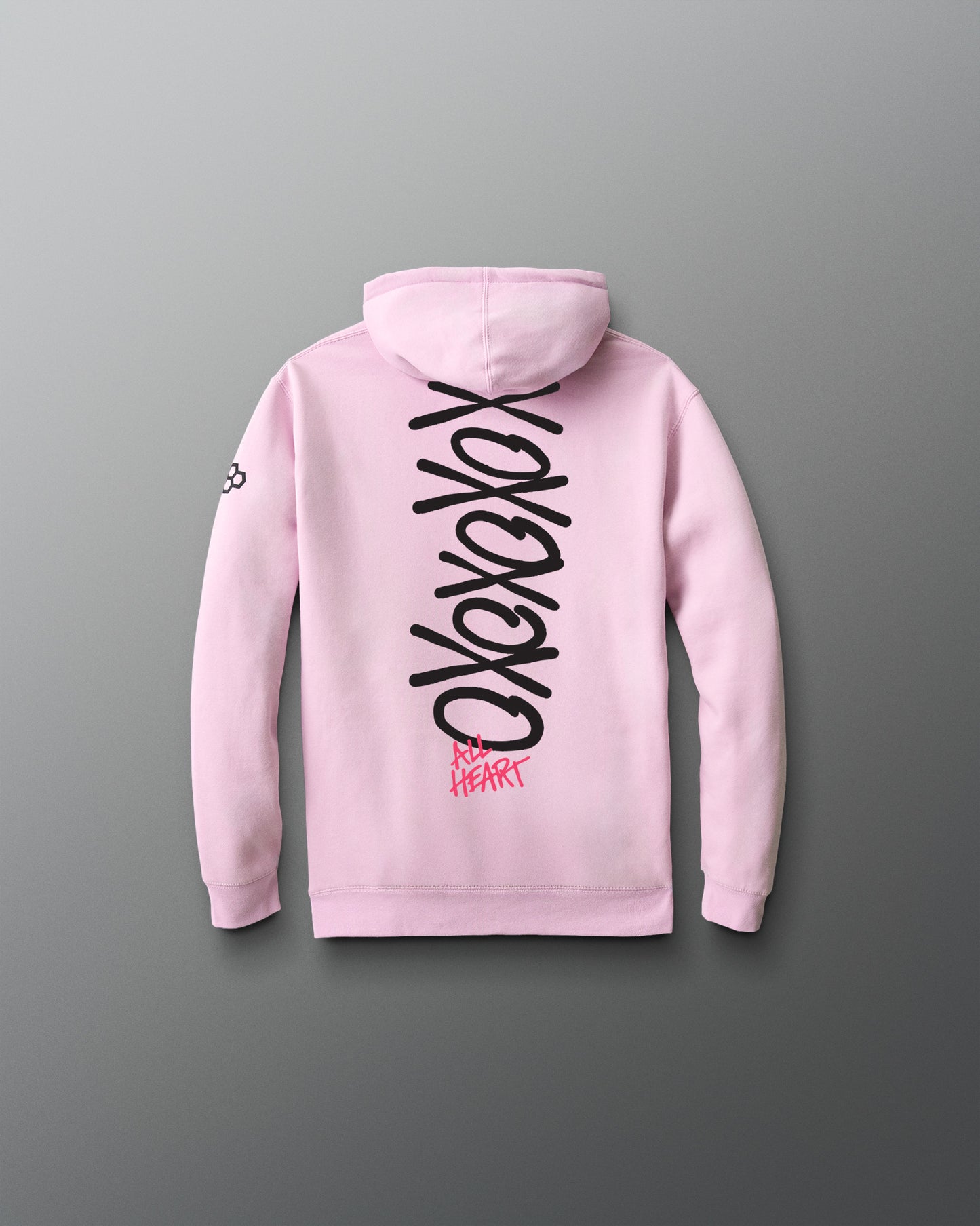 Pink hoodie with black and red text on the back against a gray background
