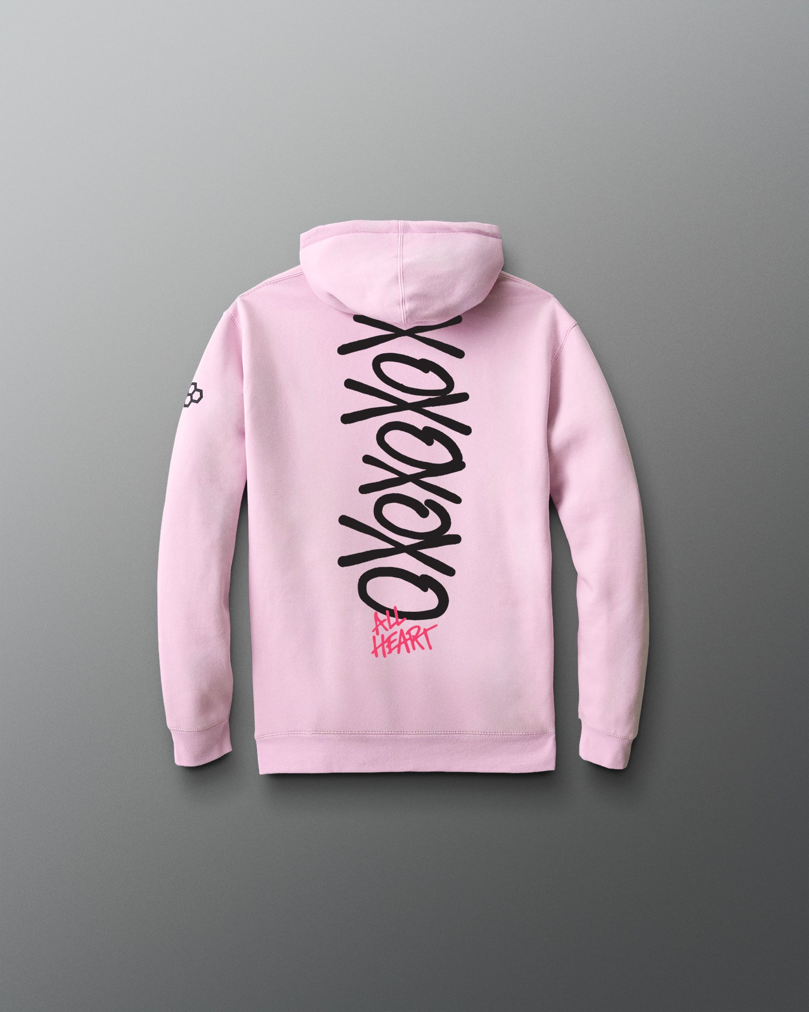 Pink hoodie with black and red text on the back against a gray background