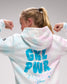 Person wearing a hoodie with 'GIRL PWR' text on the back, standing against a plain background.