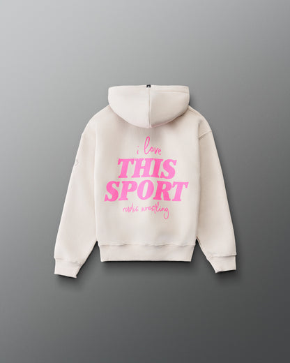 RUDIS Love This Sport Youth Relaxed Comfort Fleece Hoodie in Bone, front view featuring a bright pink chest graphic, matching sleeve accents, kangaroo pocket, and ribbed cuffs and hem.