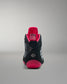 Black and pink wrestling shoe on a gray background
