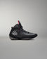 Black wrestling shoes with a red accent on a gray background