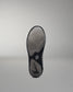 Black wrestling shoe sole with a brand logo on a gray background