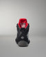 Black wrestling shoe with red lining on a gray background