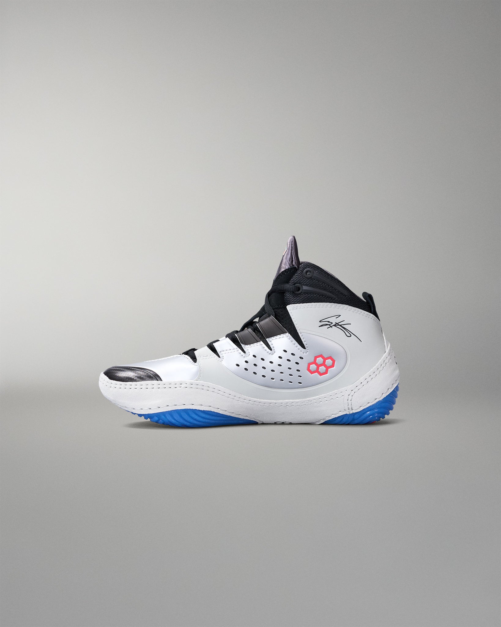 White wrestling shoe with black and blue accents on a gray background
