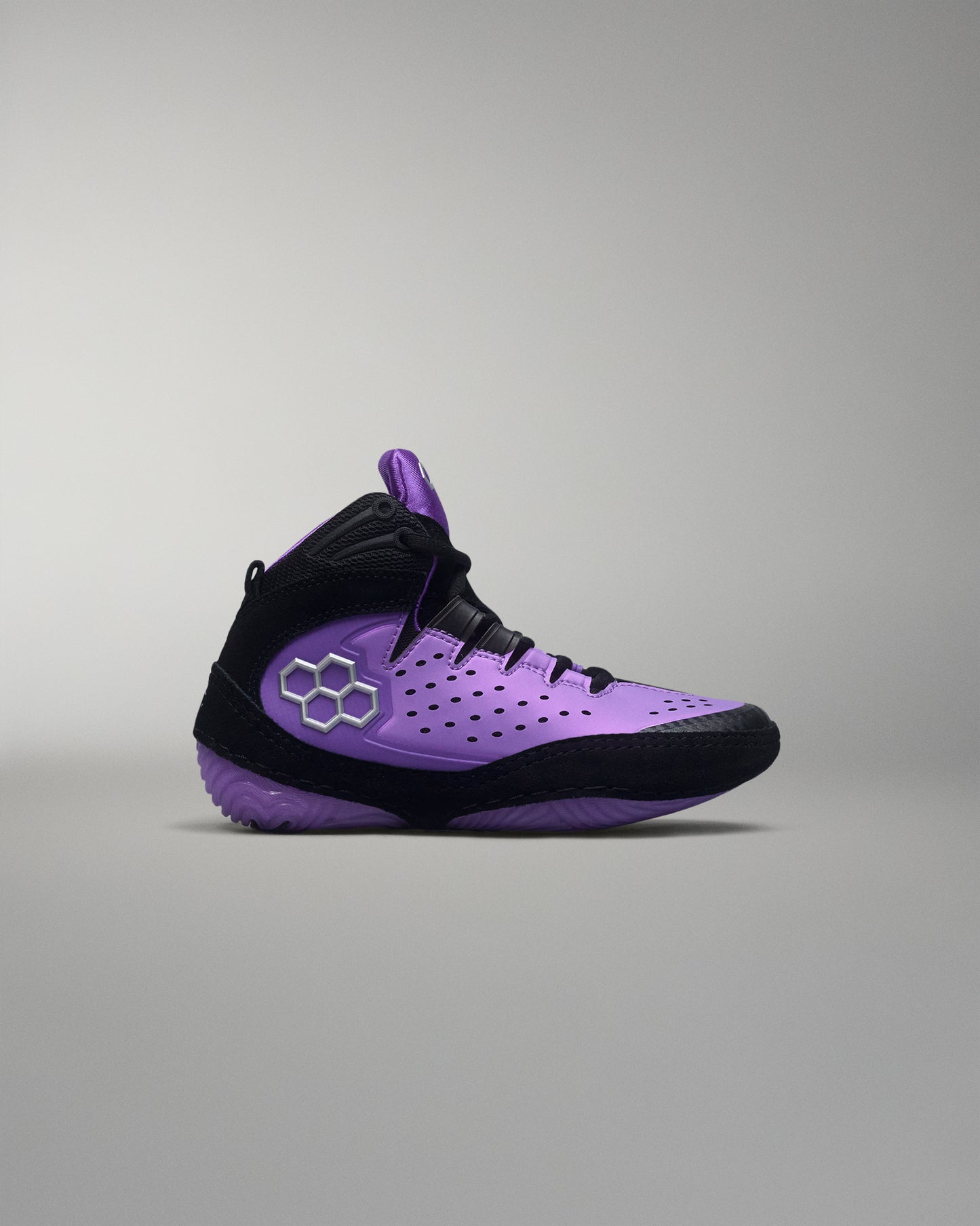 Purple and black wrestling shoe on a gray background