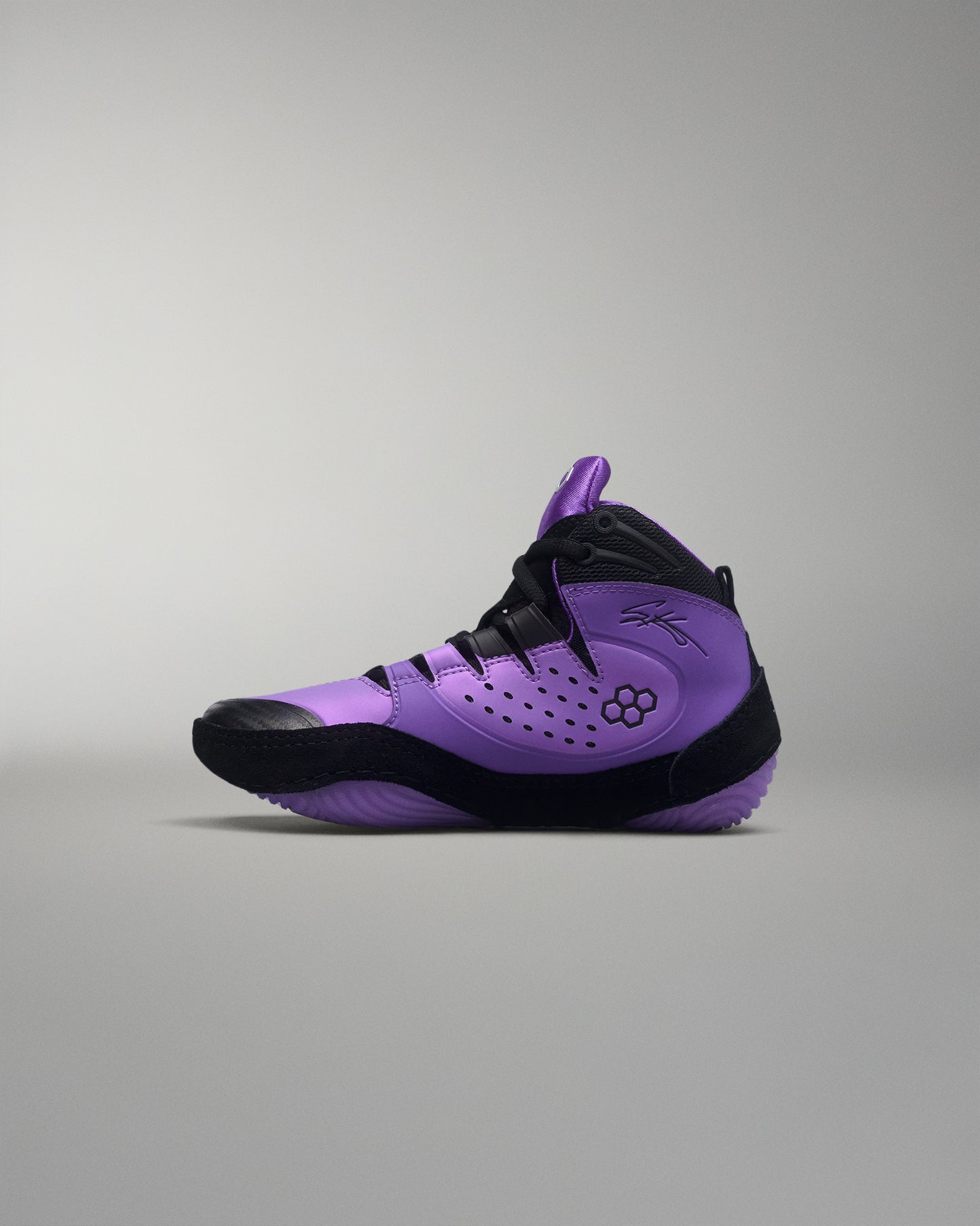 Purple and black wrestling shoe on a gray background