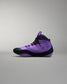 Purple and black wrestling shoe on a gray background