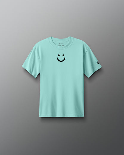 Light blue t-shirt with a smiley face design on a gray background