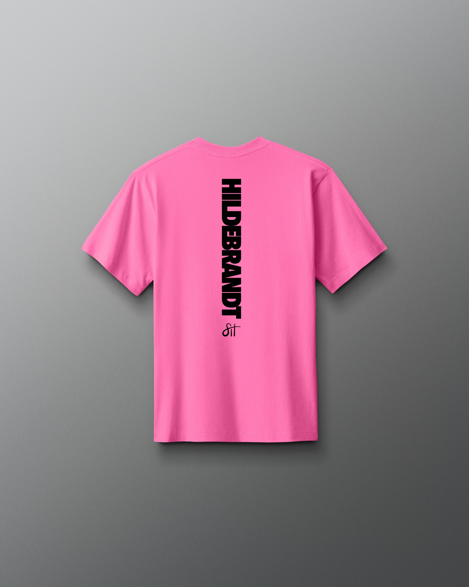 Pink t-shirt with 'Hilderbrandt' logo on the back against a gray background