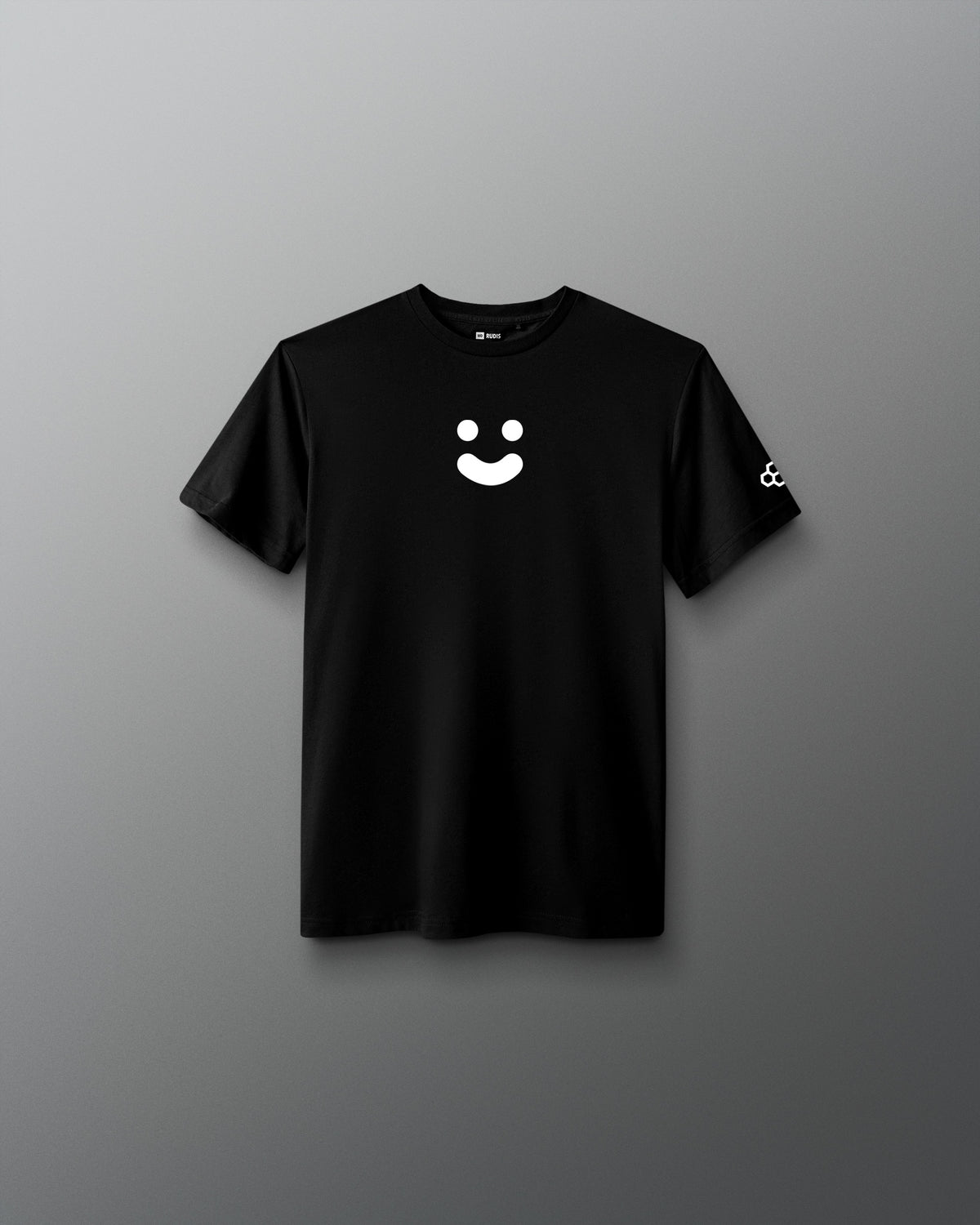 A black short-sleeve crewneck t-shirt featuring a white minimalist smiley face graphic on the center chest and a small white logo on the left sleeve, displayed against a neutral gray gradient background.