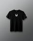 A black short-sleeve crewneck t-shirt featuring a white minimalist smiley face graphic on the center chest and a small white logo on the left sleeve, displayed against a neutral gray gradient background.
