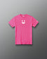 A bright pink short-sleeve t-shirt with a white minimalist smiley face graphic on the center chest and a small white logo on the left sleeve, displayed flat against a dark gray gradient background.