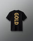 Back view of the black RUDIS Youth JB Gold Heavyweight T-Shirt featuring oversized vertical gold “GOLD” lettering with Jordan Burroughs and RUDIS details beneath the graphic.