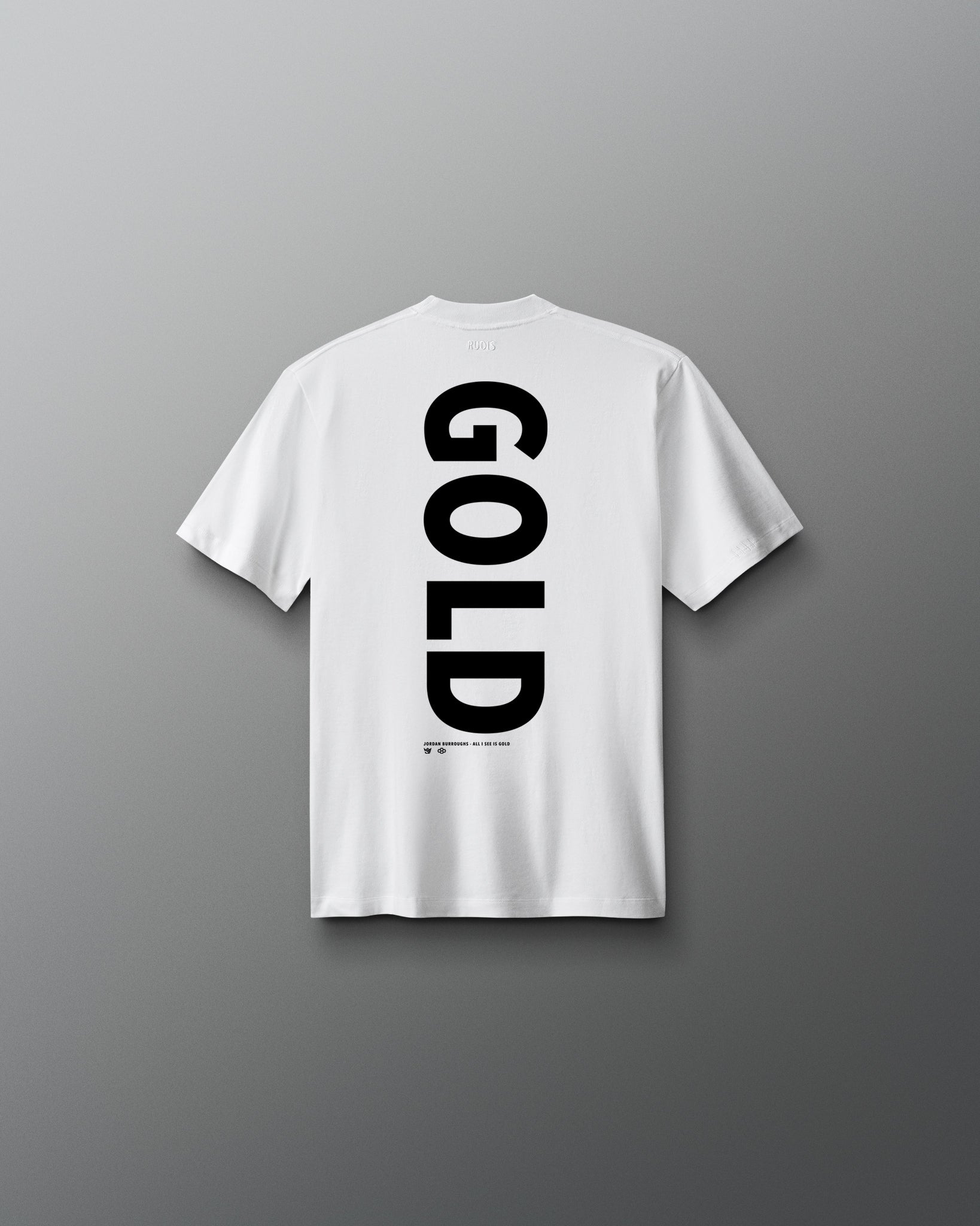 Back view of the white RUDIS Youth JB Gold Heavyweight T-Shirt featuring oversized vertical black “GOLD” lettering with Jordan Burroughs and RUDIS details beneath the graphic.