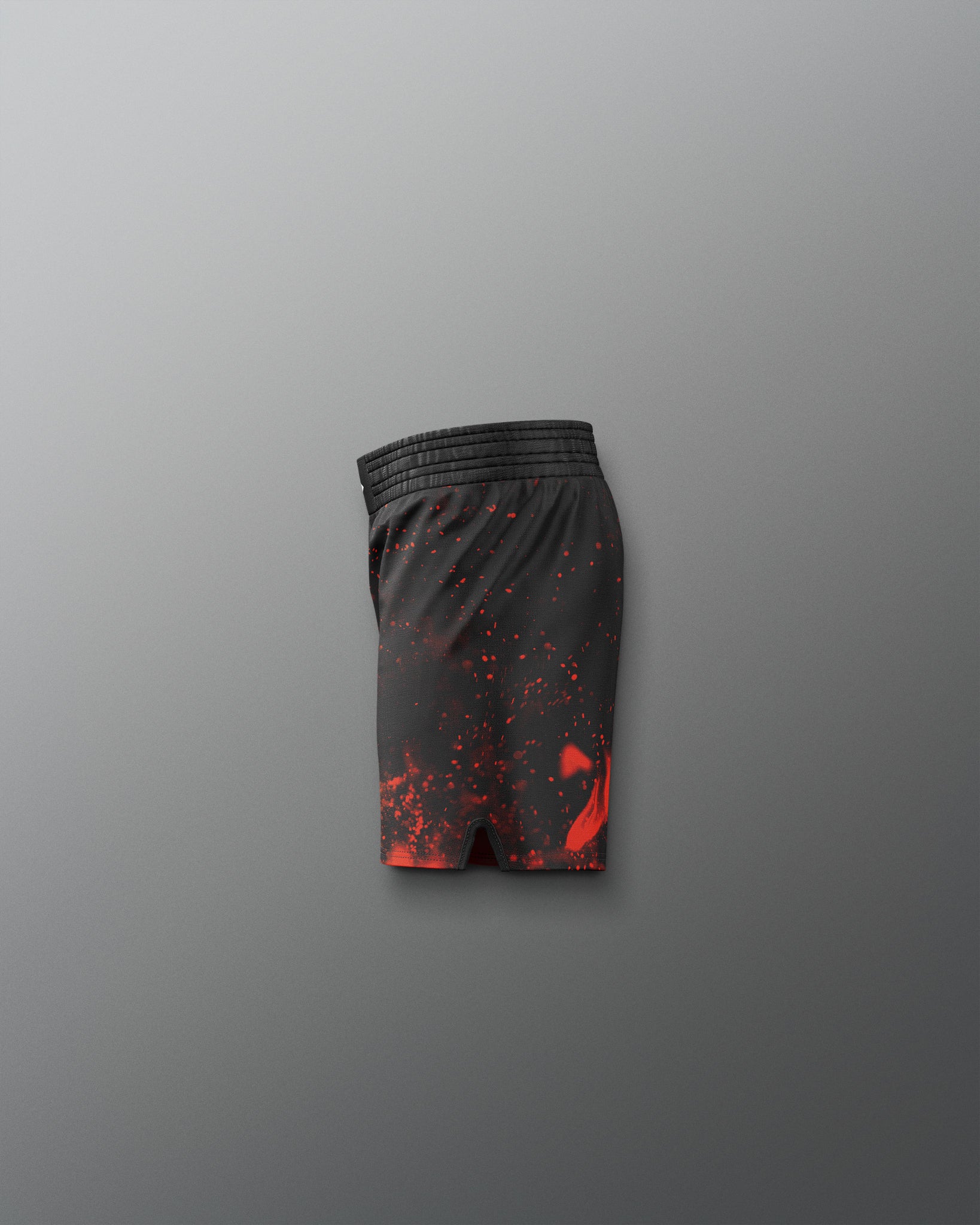 Black shorts with red splatter pattern on a gray background