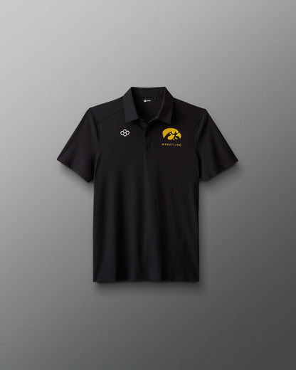 Black polo shirt with logos on a gray background