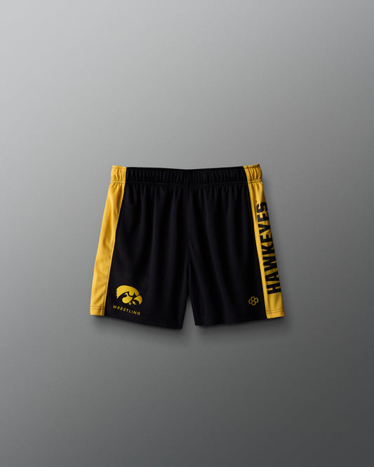Black shorts with yellow accents and logos on a gray background