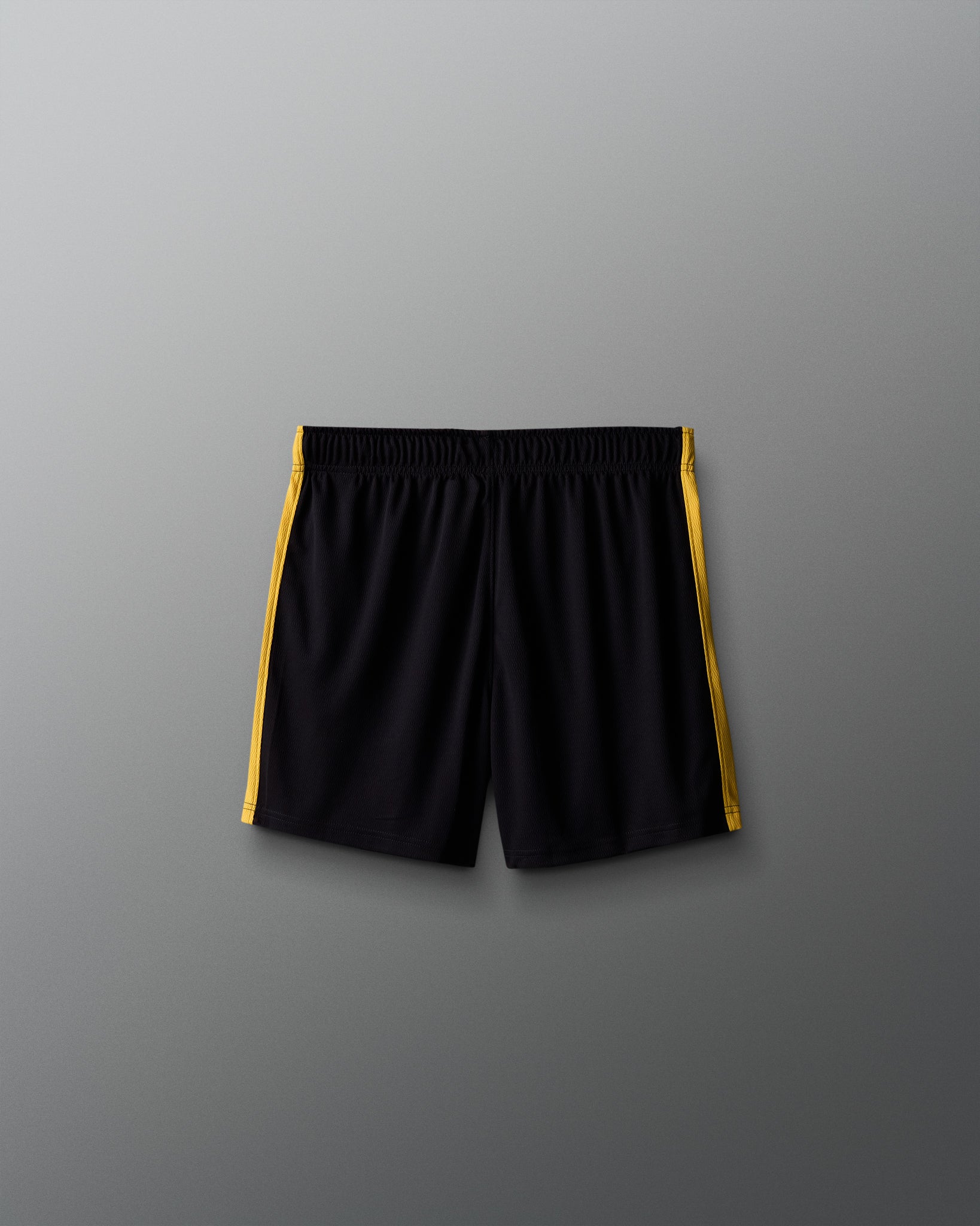 Black shorts with yellow accents on a gray background
