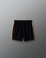 Black shorts with yellow accents on a gray background