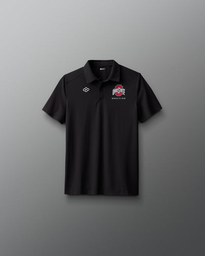 Black polo shirt with logos on a gray background